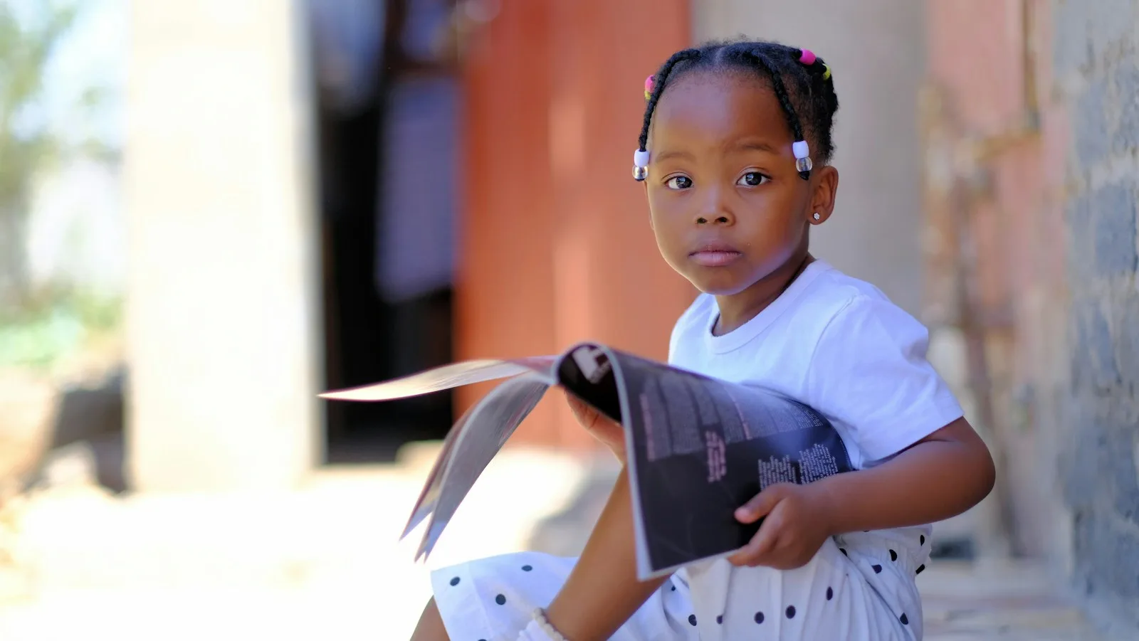 A little girl reading a book
