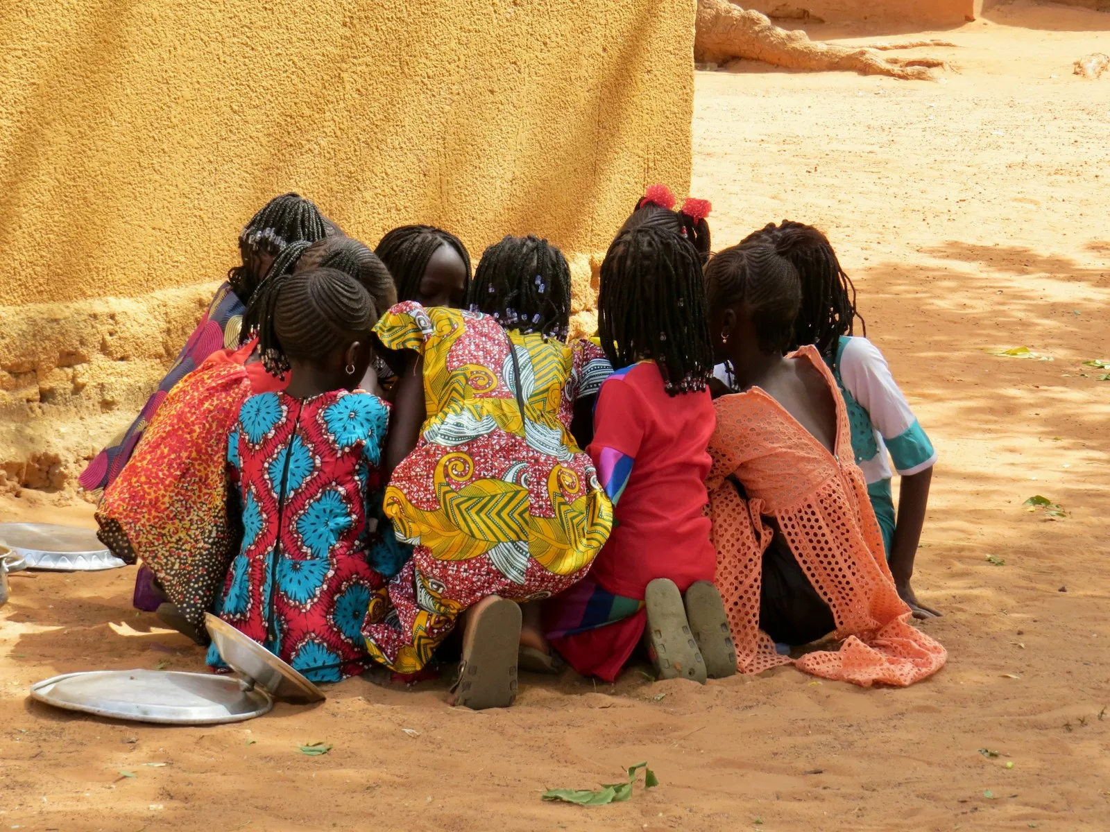 Children sitting together on the ground