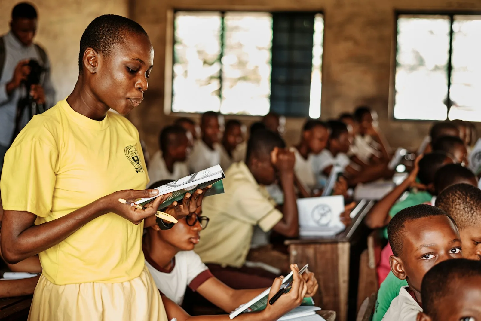 A teacher standing in front of a group of children