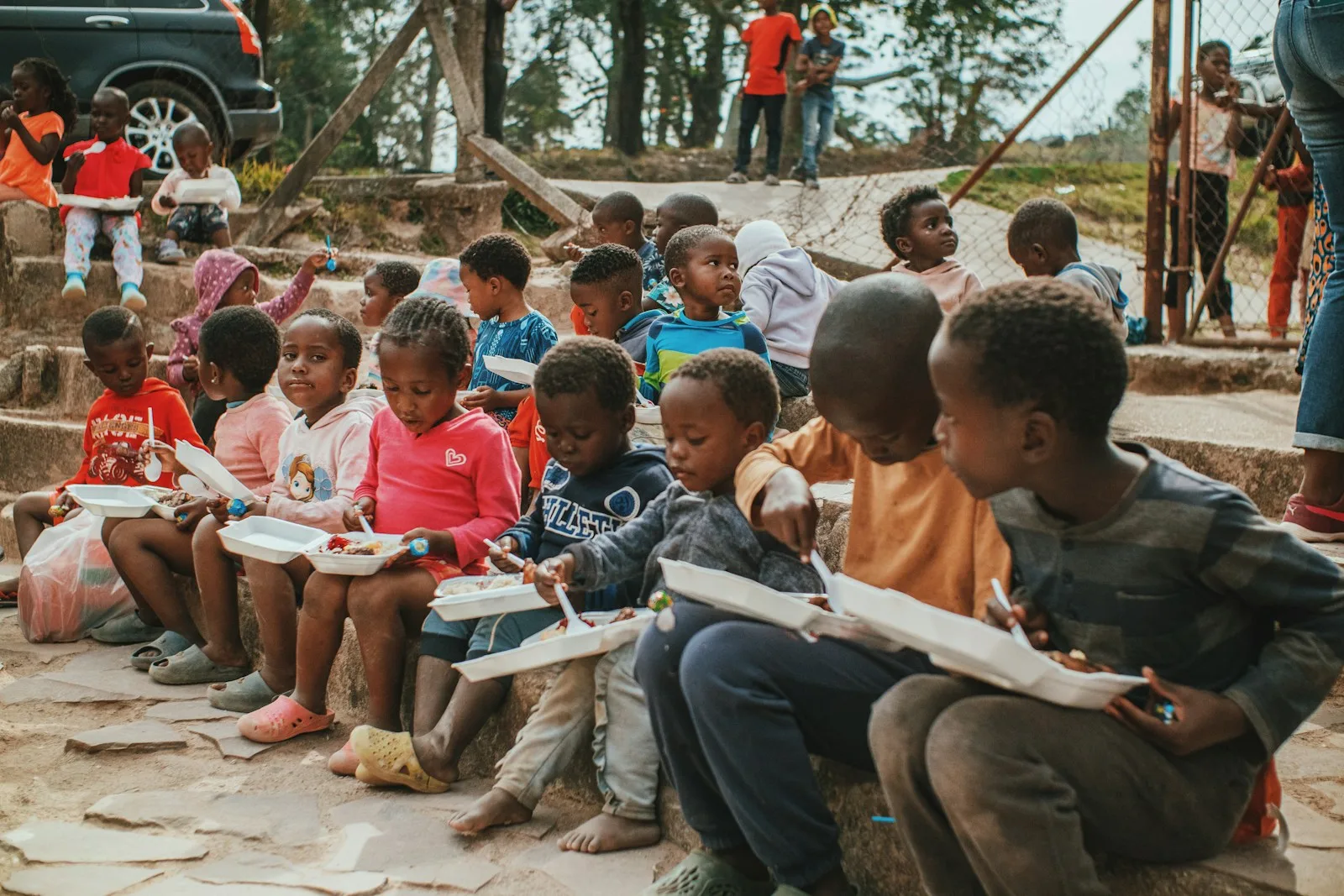 Children sitting on steps with books